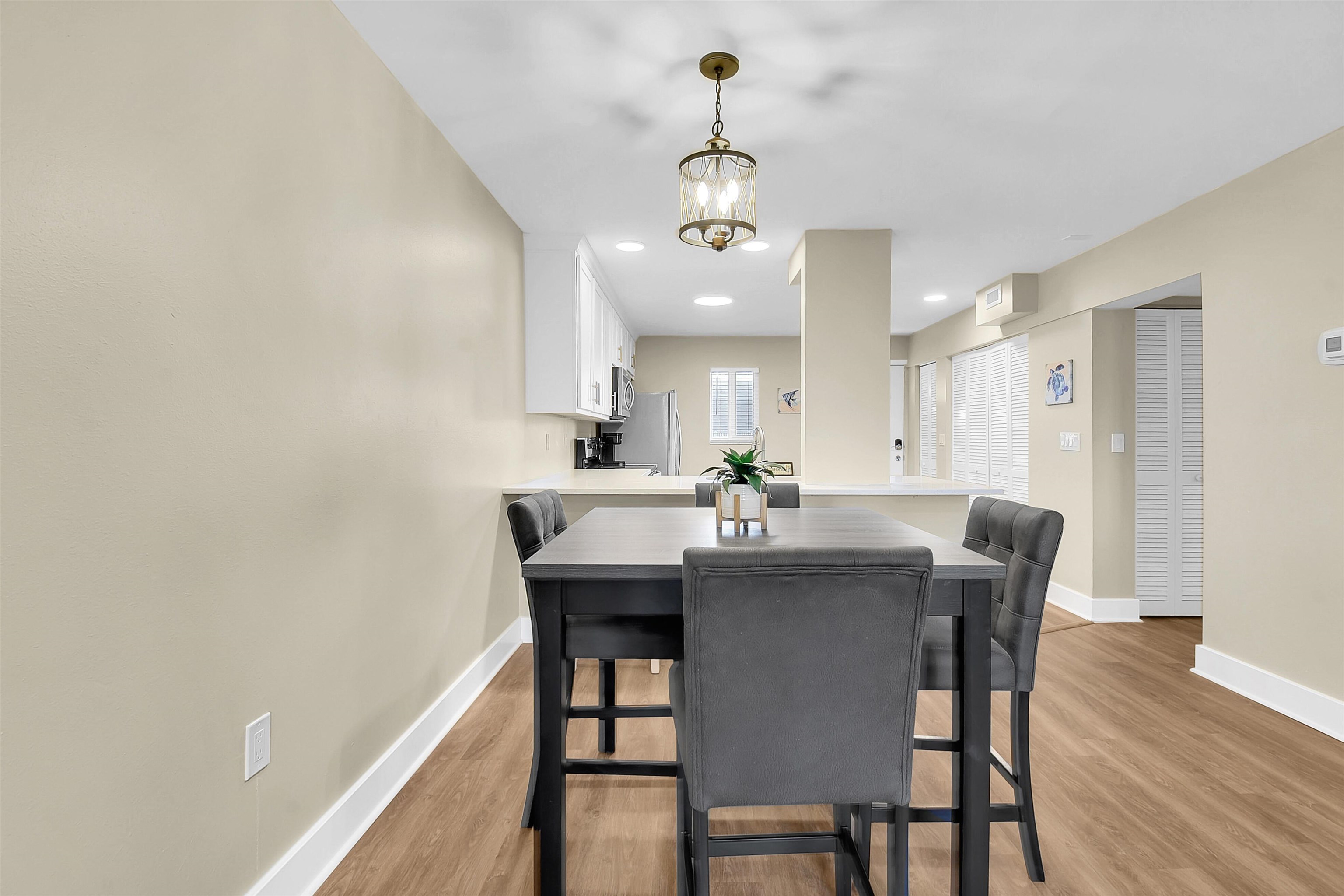 4 Ocean Trace Road, Unit 106 St. Augustine, FL 32080 - Photo 9 of 18 a view of a dining room with furniture and wooden floor