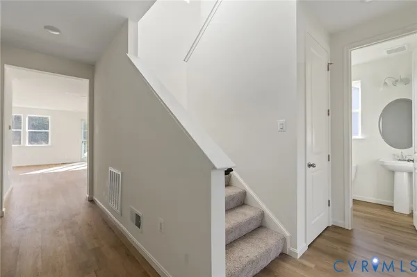 a view of entryway and hall with wooden floor