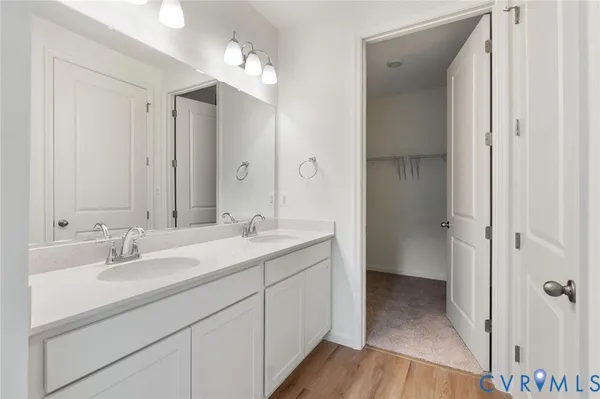 a bathroom with a double vanity sink mirror and shower