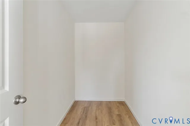 a view of a room with wooden floor