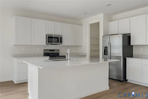 a kitchen with a refrigerator a stove top oven a sink and dishwasher
