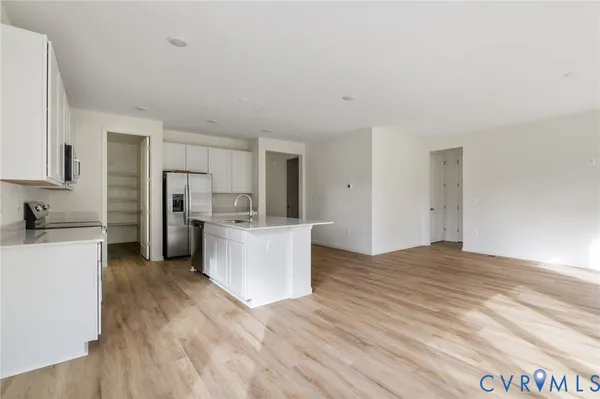 a kitchen with stainless steel appliances a refrigerator and a stove top oven