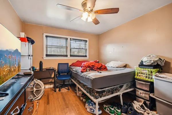a bedroom with a bed and a chandelier