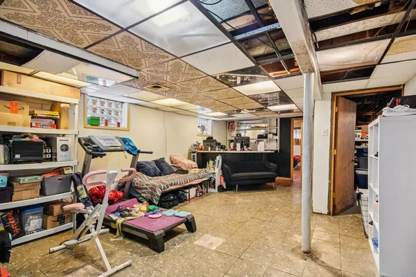 a living room with lots of furniture and clutter