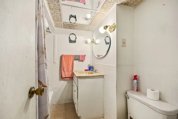 a bathroom with a sink mirror and toilet