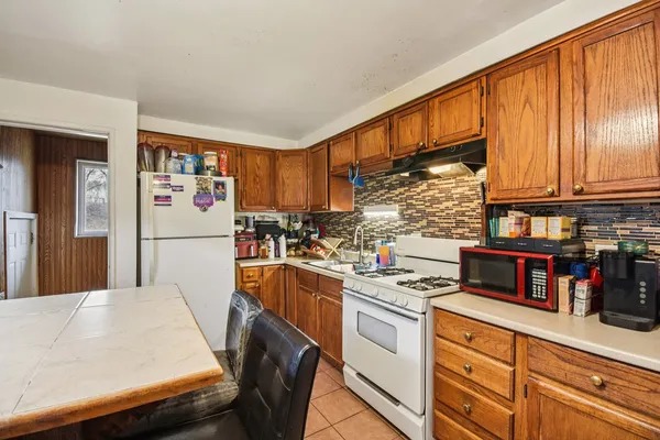 a kitchen with stainless steel appliances granite countertop a refrigerator sink and cabinets