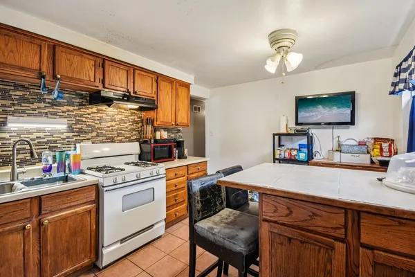 a kitchen with a sink cabinets and wooden floor