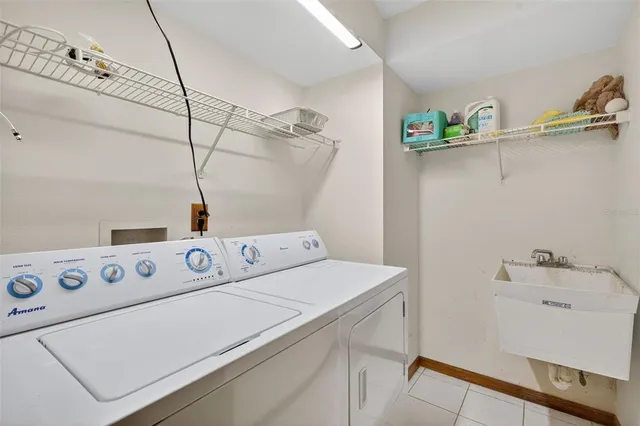 a bathroom with a tub a sink and a large mirror