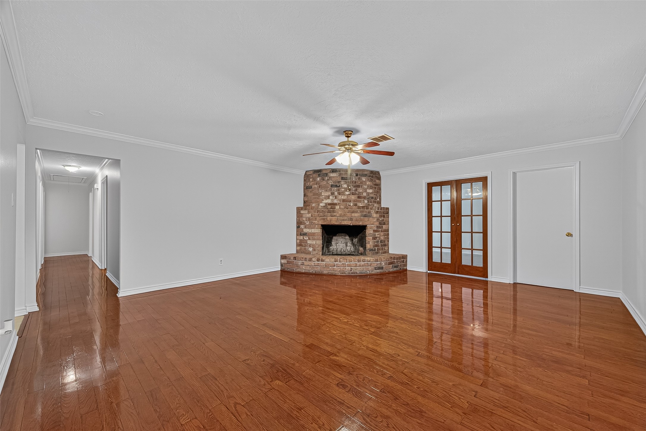 3122 Kueck Road Rosenberg, TX 77471 - Photo 3 of 25 a view of a livingroom with wooden floor and a fireplace