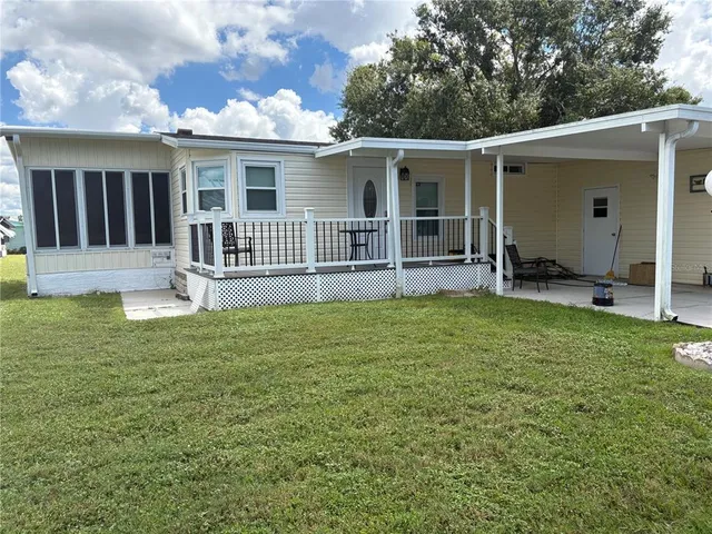 a backyard of a house with barbeque oven table and chairs