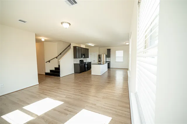 a view of kitchen with furniture and wooden floor