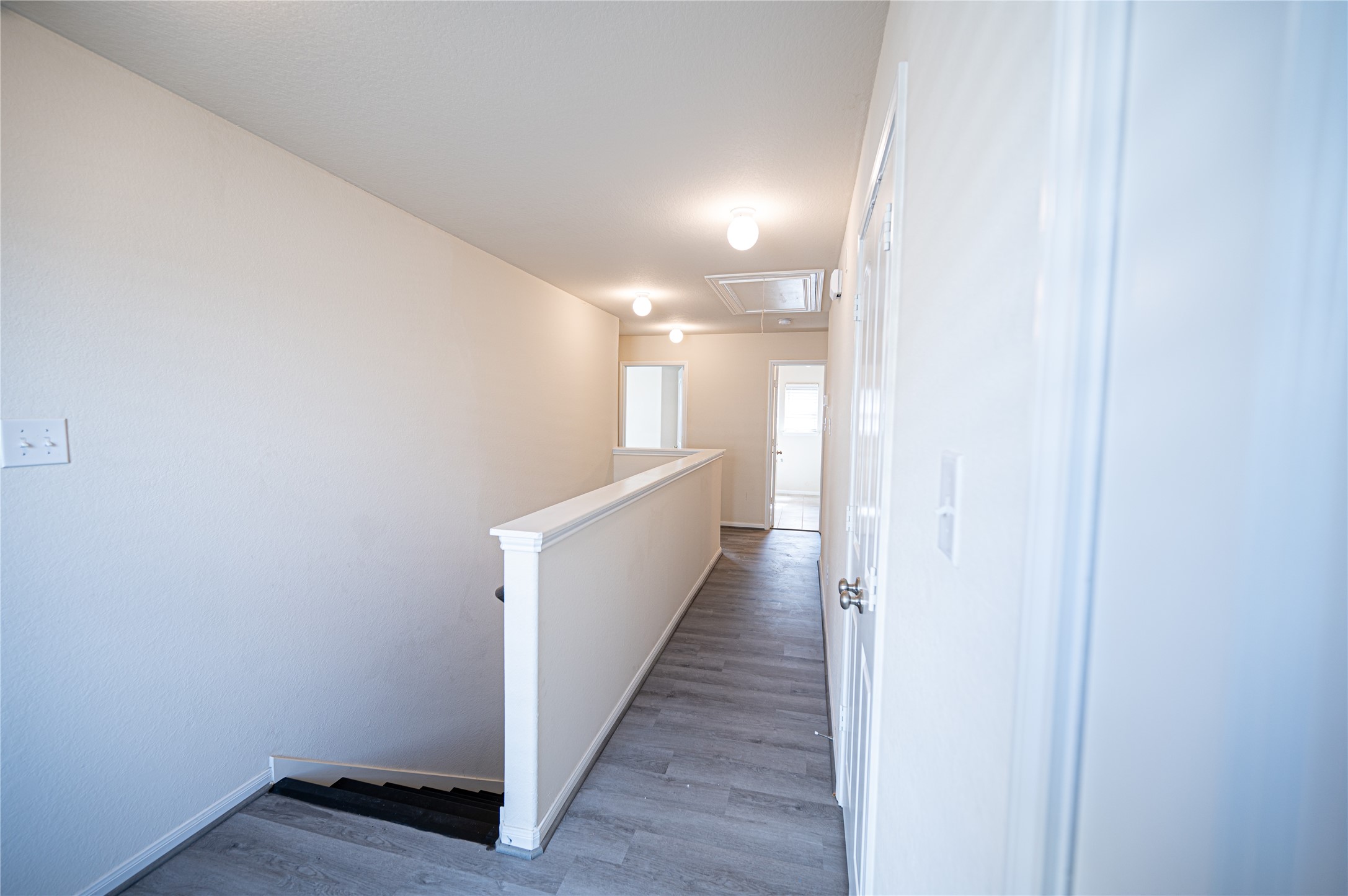 10730 Nathaniel Valley Path Houston, TX 77016 - Photo 17 of 38 a view of a hallway with wooden floor
