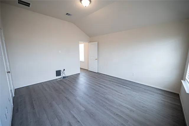 an empty room with wooden floor