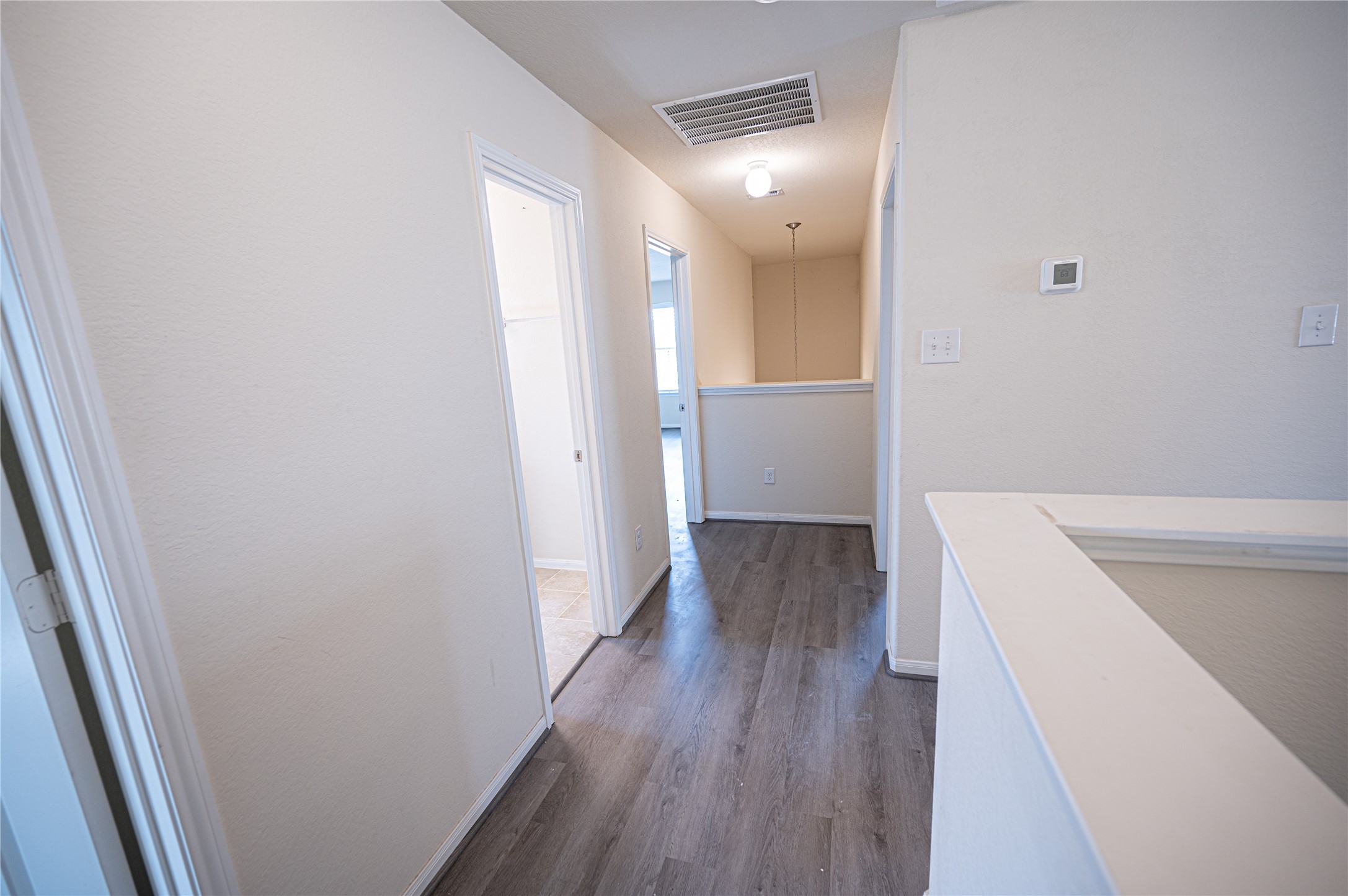 10730 Nathaniel Valley Path Houston, TX 77016 - Photo 24 of 38 a view of a hallway with wooden floor