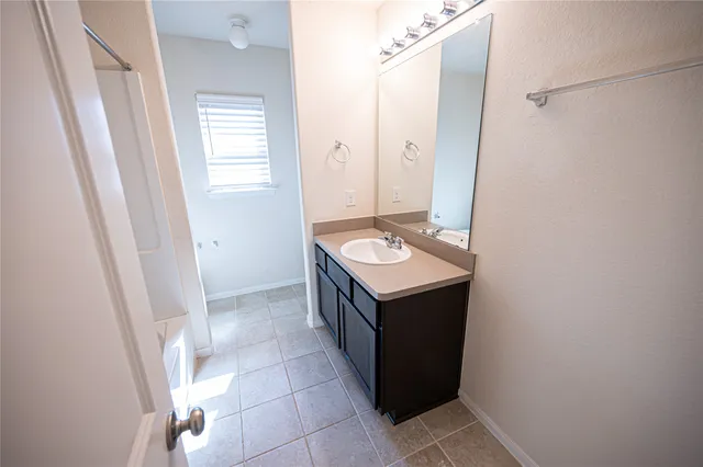 a bathroom with a sink vanity and a mirror