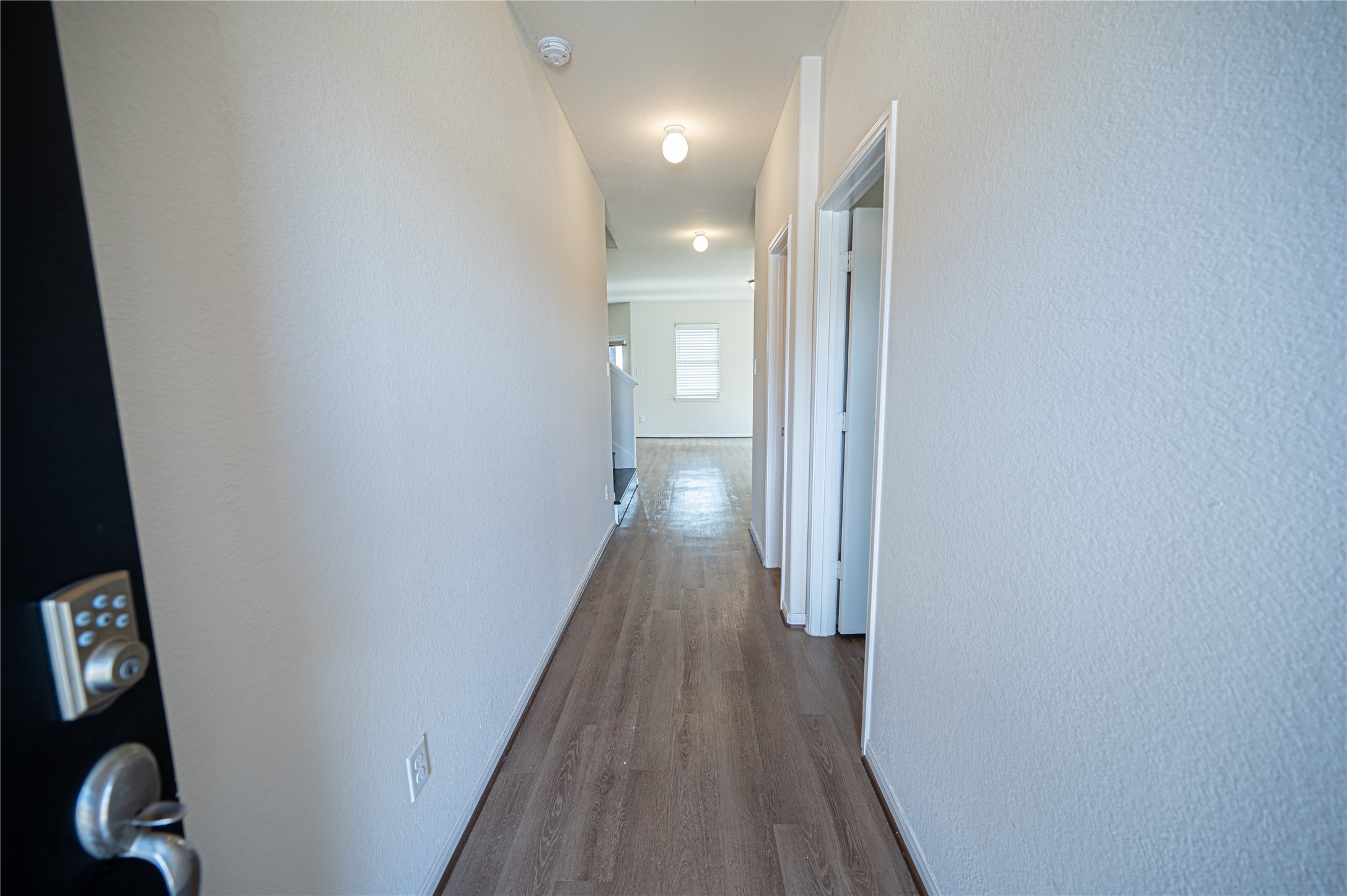 10730 Nathaniel Valley Path Houston, TX 77016 - Photo 3 of 38 a view of a hallway with wooden floor