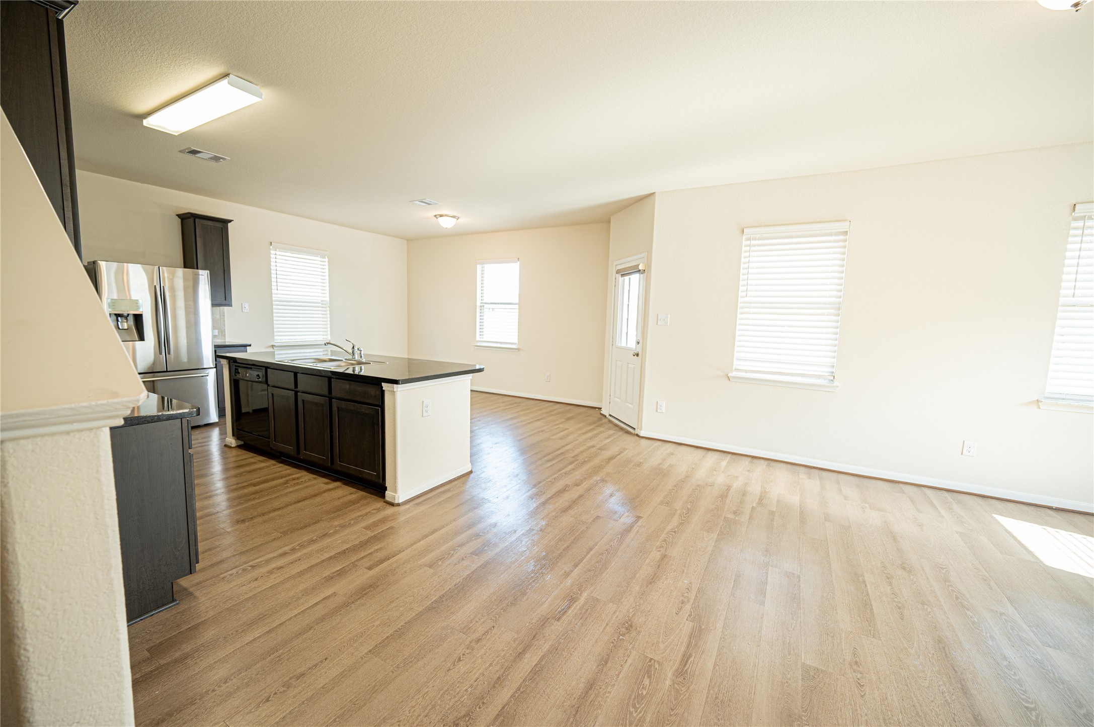 10730 Nathaniel Valley Path Houston, TX 77016 - Photo 7 of 38 a view of kitchen with wooden floor and electronic appliances