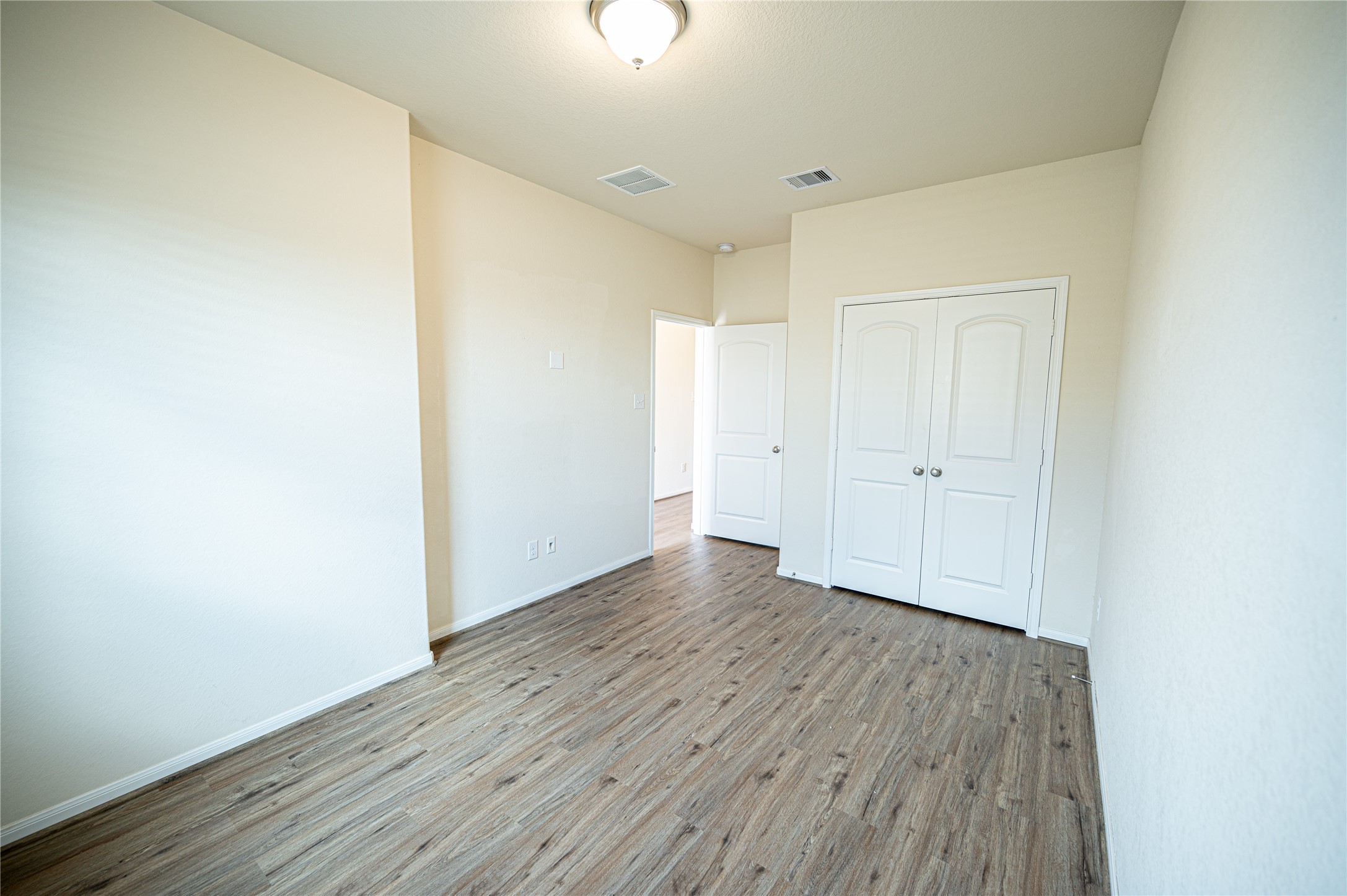 10730 Nathaniel Valley Path Houston, TX 77016 - Photo 9 of 38 a view of an empty room with wooden floor