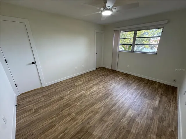 wooden floor in an empty room with a window