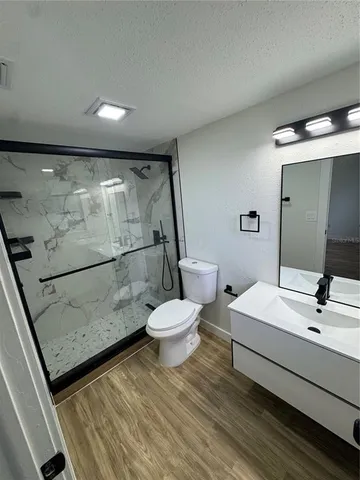 a bathroom with a sink toilet and shower