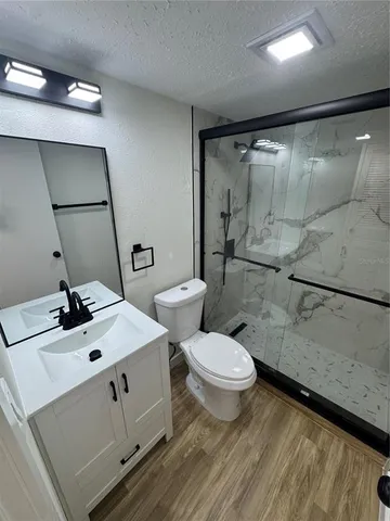 a bathroom with a sink toilet and shower