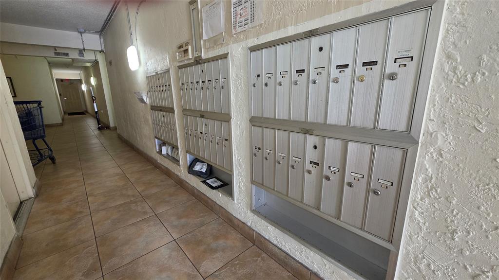 253 South Cypress Road, Unit 225 Pompano Beach, FL 33060 - Photo 21 of 23 a view of a hallway with wooden floor