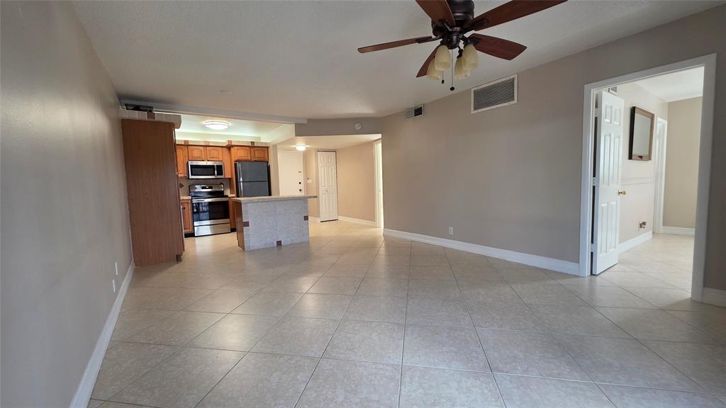 253 South Cypress Road, Unit 225 Pompano Beach, FL 33060 - Photo 5 of 23 a view of a livingroom with a kitchen