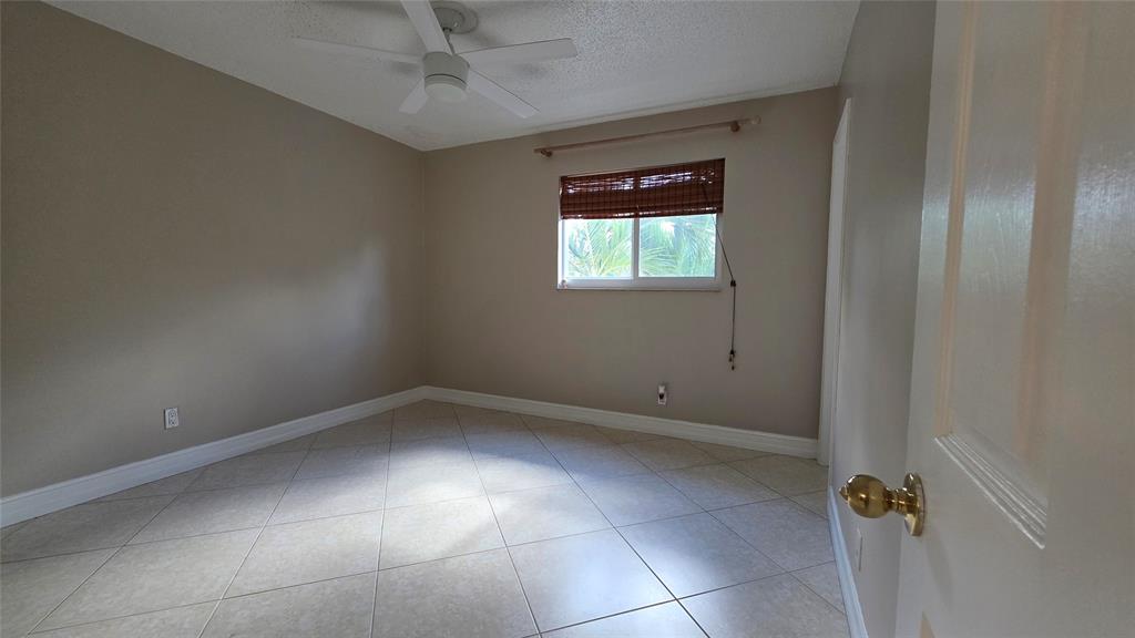253 South Cypress Road, Unit 225 Pompano Beach, FL 33060 - Photo 7 of 23 an empty room with a window