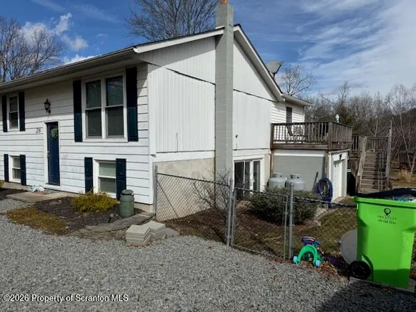 a view of a house with a patio and backyard