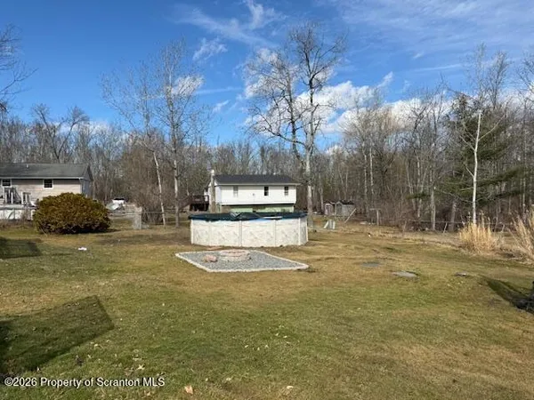 a view of a yard with swimming pool