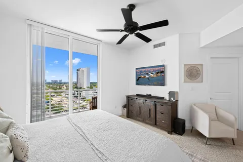 a bedroom with a bed and a large mirror