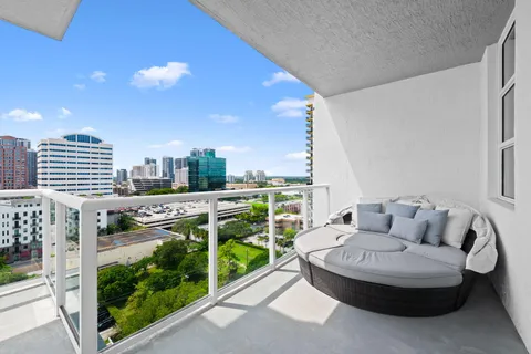 a balcony with furniture and city view