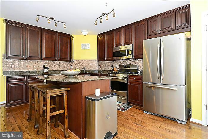22751 Verde Gate Terrace Ashburn, VA 20148 - Photo 11 of 29 a kitchen with stainless steel appliances granite countertop a refrigerator stove a sink and dishwasher