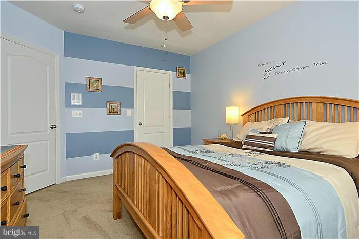 22751 Verde Gate Terrace Ashburn, VA 20148 - Photo 14 of 29 a bedroom with a bed and a view of kitchen