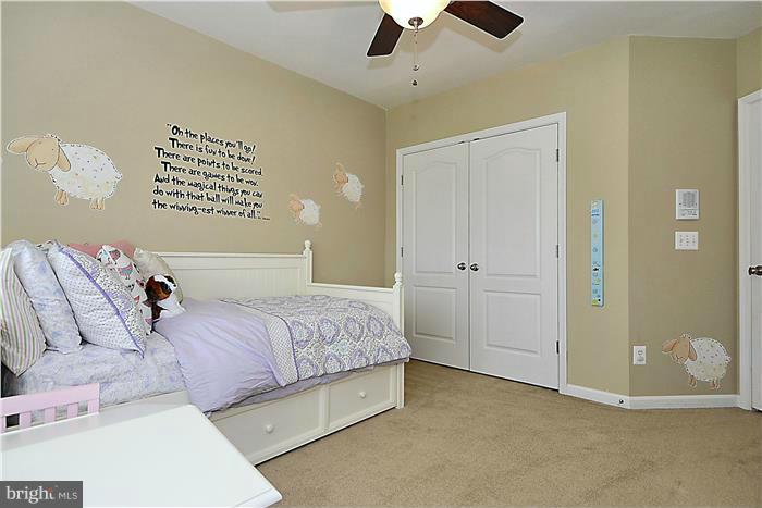 22751 Verde Gate Terrace Ashburn, VA 20148 - Photo 16 of 29 a bedroom with a bed and a chandelier