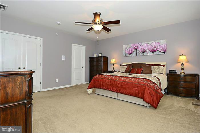 22751 Verde Gate Terrace Ashburn, VA 20148 - Photo 17 of 29 a bedroom with a bed and a chandelier