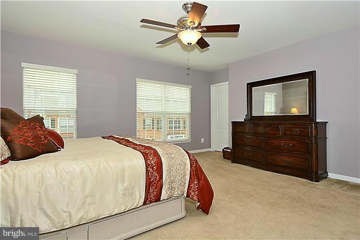 22751 Verde Gate Terrace Ashburn, VA 20148 - Photo 18 of 29 a bedroom with a bed and a dresser