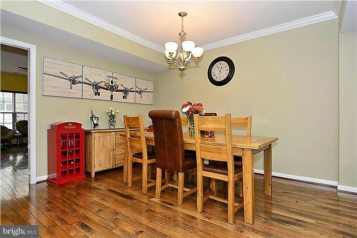 22751 Verde Gate Terrace Ashburn, VA 20148 - Photo 19 of 29 a view of a dining room with furniture and wooden floor