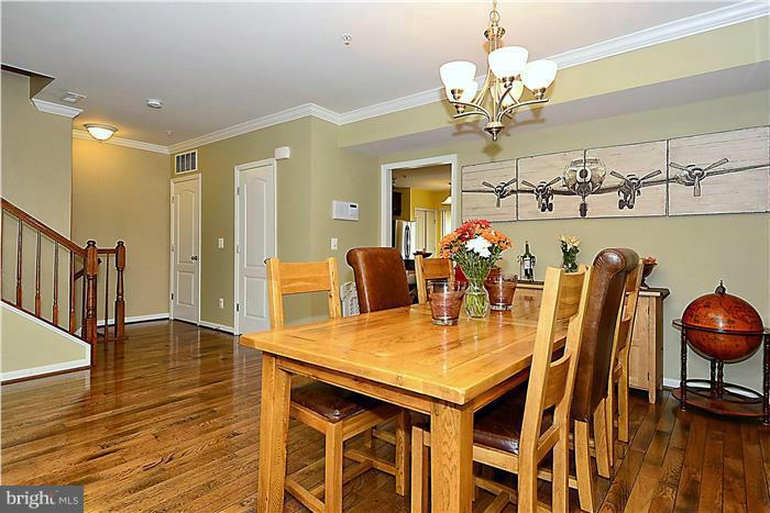 22751 Verde Gate Terrace Ashburn, VA 20148 - Photo 3 of 29 a view of a dining room with furniture and wooden floor
