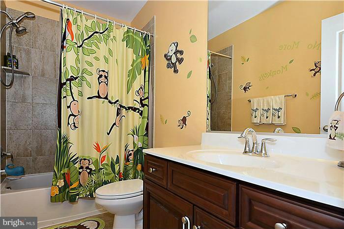 22751 Verde Gate Terrace Ashburn, VA 20148 - Photo 24 of 29 a bathroom with a granite countertop sink a toilet and a mirror