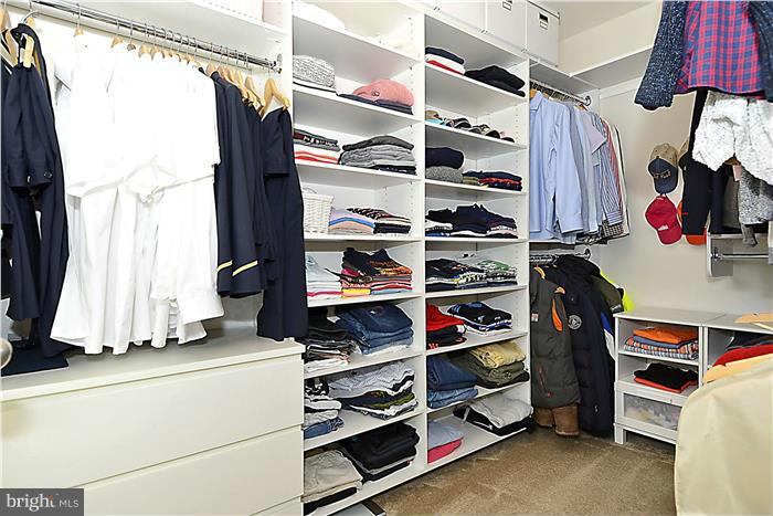 22751 Verde Gate Terrace Ashburn, VA 20148 - Photo 27 of 29 a view of walk in closet with clothes and shoes