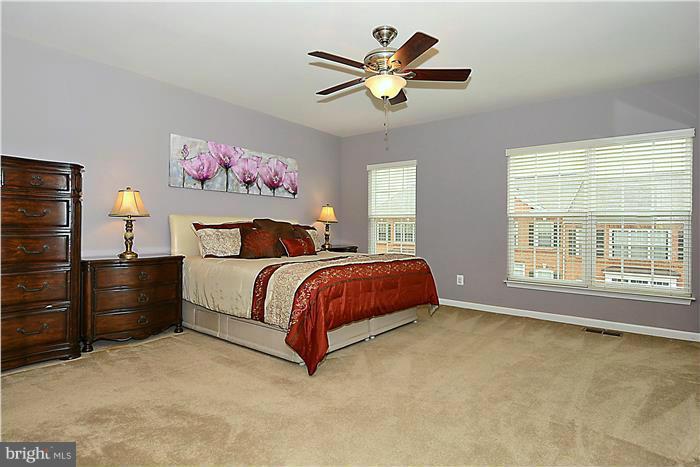 22751 Verde Gate Terrace Ashburn, VA 20148 - Photo 5 of 29 a bedroom with a bed and a chandelier