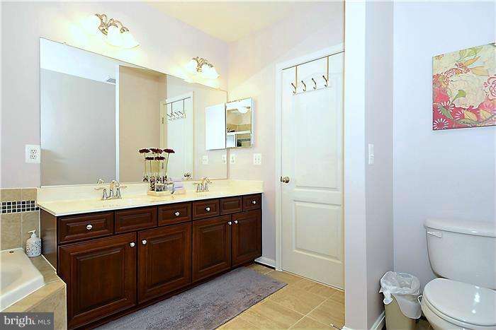 22751 Verde Gate Terrace Ashburn, VA 20148 - Photo 7 of 29 a spacious bathroom with a sink a toilet and a mirror