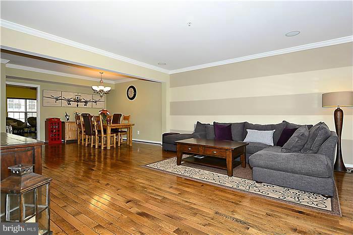 22751 Verde Gate Terrace Ashburn, VA 20148 - Photo 8 of 29 a living room with furniture and wooden floor