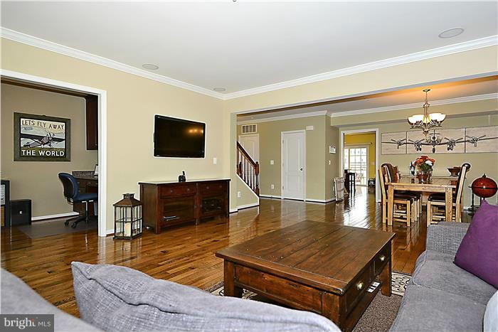 22751 Verde Gate Terrace Ashburn, VA 20148 - Photo 9 of 29 a living room with furniture and a flat screen tv