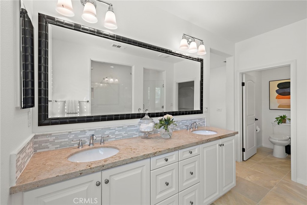 90 Galan Street Rancho Mission Viejo, CA 92694 - Photo 14 of 67 a bathroom with a granite countertop double vanity sink and a mirror