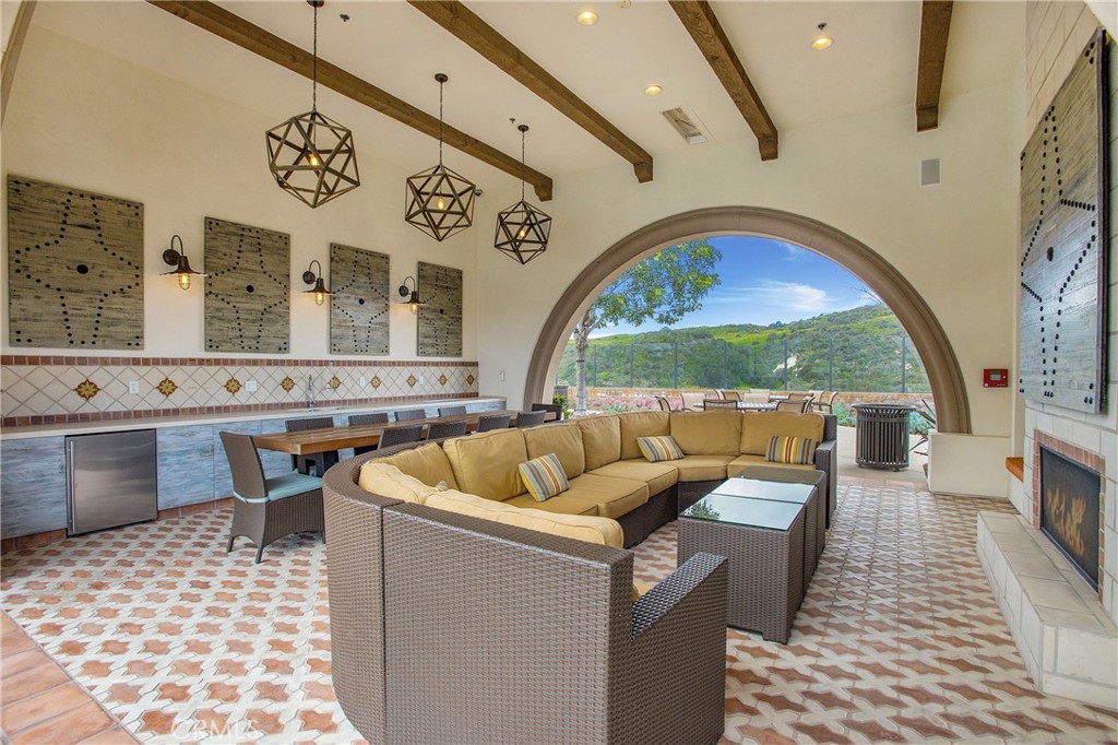90 Galan Street Rancho Mission Viejo, CA 92694 - Photo 49 of 67 a living room with furniture a rug and a fireplace