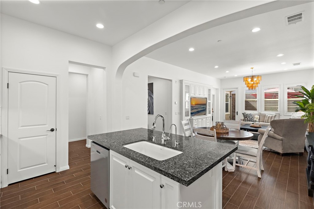 90 Galan Street Rancho Mission Viejo, CA 92694 - Photo 10 of 67 a kitchen island with granite countertop a sink and a stove