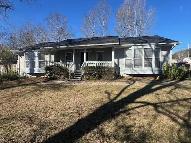 a front view of a house with sitting area