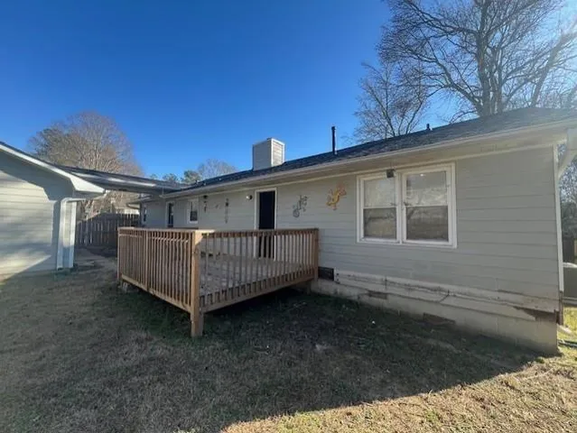 a view of a house with a wooden deck